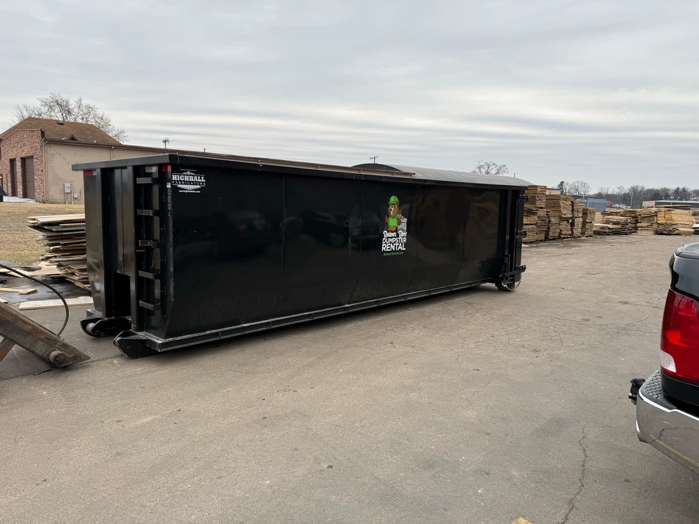 Extra large roll off dumpster rental at a yard showing big size options for construction debris and heavy cleanup jobs.